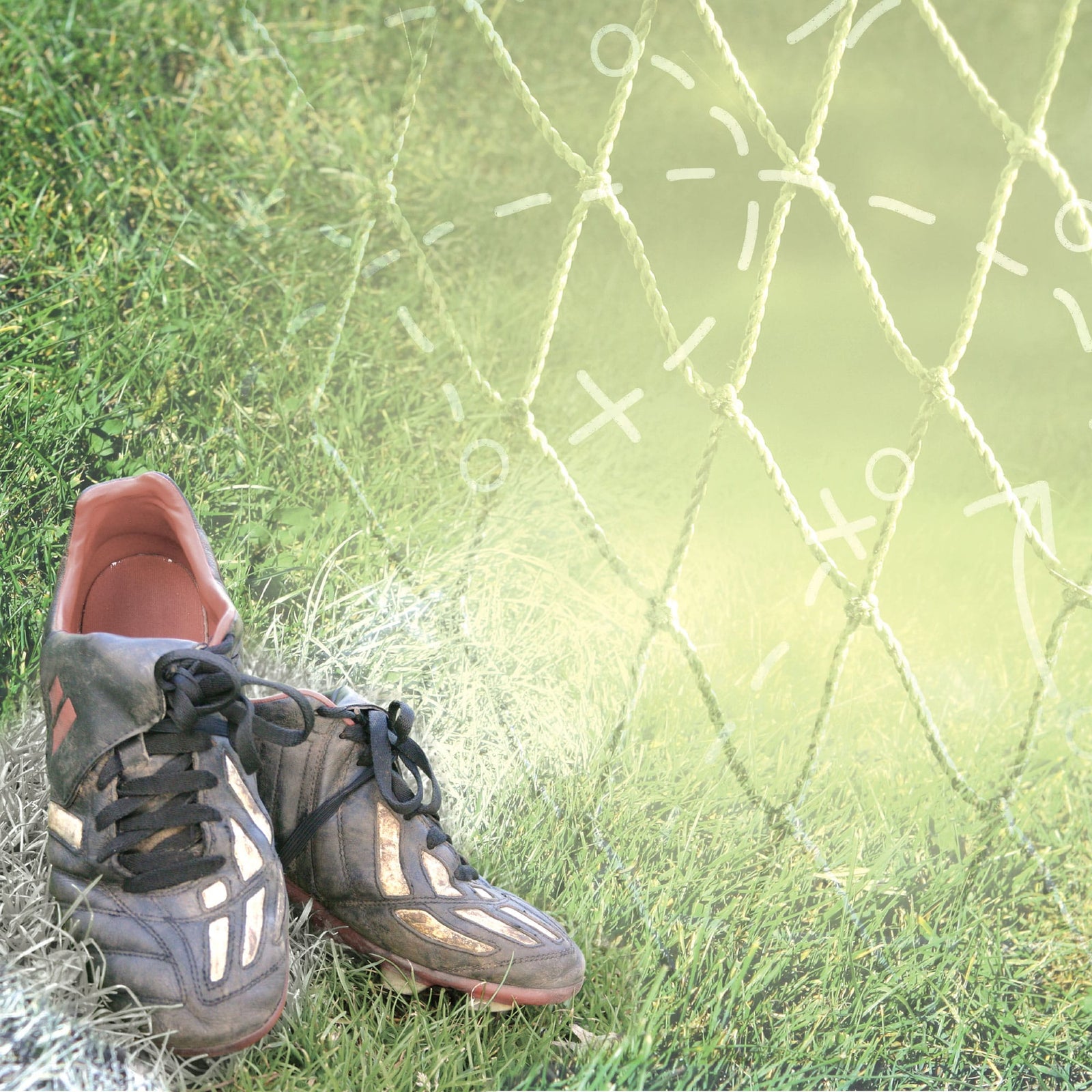 P-2416E - Soccer Cleats 12 x 12 Scrapbook Paper - Pair of black and red athletic shoes on grass next to a green mesh net with white tic-tac-toe pattern