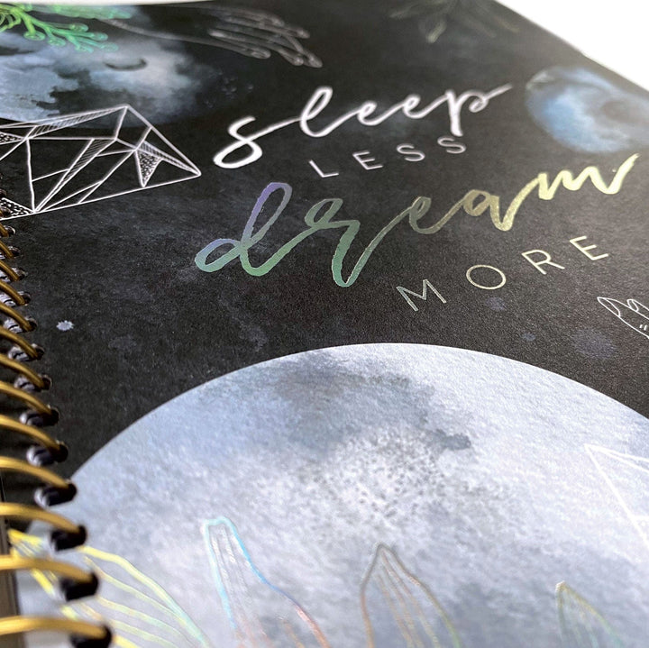 PL-2021E - Weekly Planner - Sun &amp; Moon Celestial - Spiral-bound black planner with celestial design featuring moon, geometric patterns, and iridescent foil text on cover
