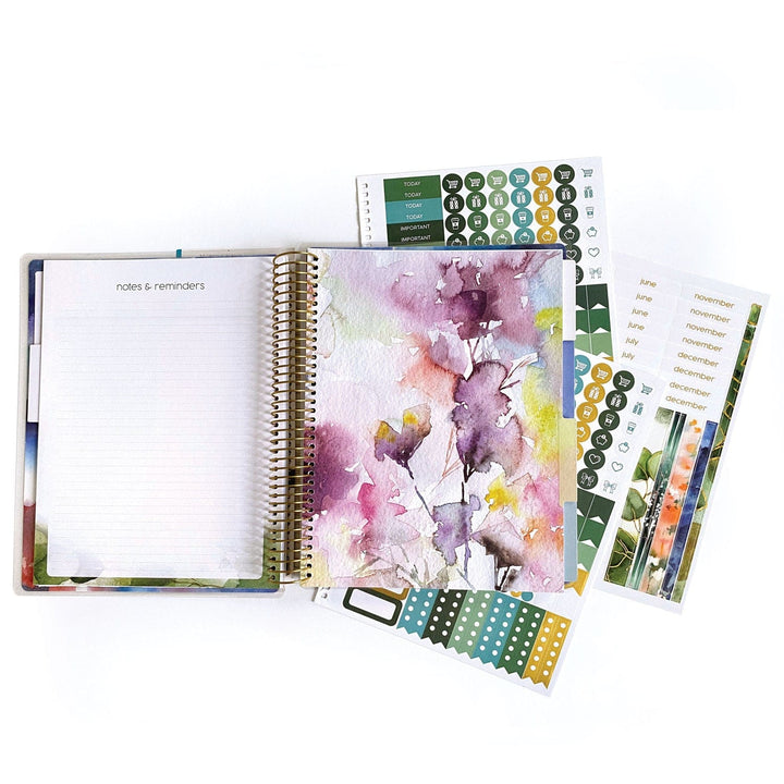 PL-2022E - Weekly Planner - Green Leaves - Spiral-bound planner with watercolor floral design, open to notes page, surrounded by decorative stickers and month tabs