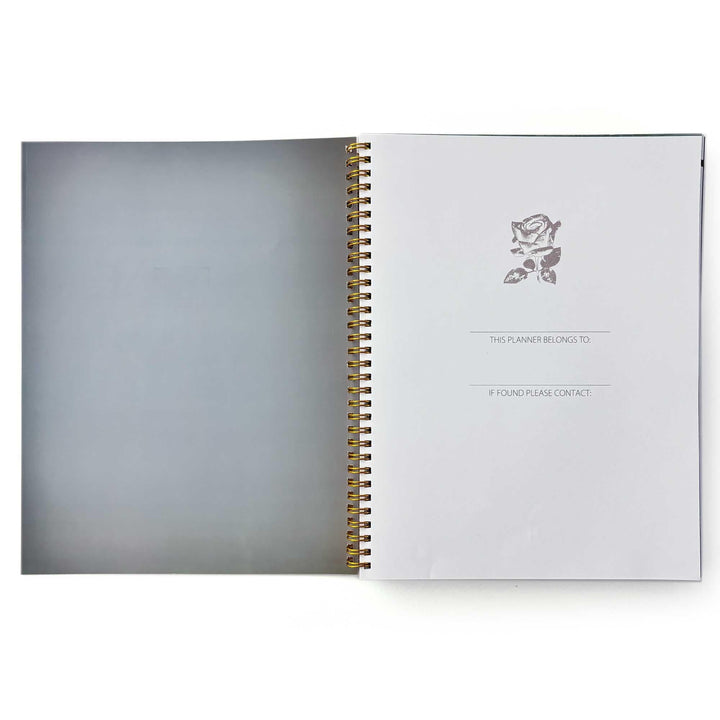 PL-2036E - Books &amp; Flowers 12 Month Undated Planner - Open spiral-bound planner with gray cover and interior page featuring rose illustration and ownership/contact information fields