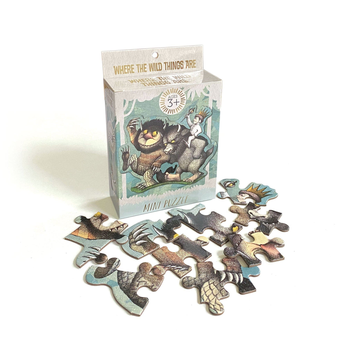 PUZ-7022E - Mini Jigsaw Puzzle - Where The Wild Things Are - Colorful mini puzzle box featuring illustrated wild creatures with scattered puzzle pieces displaying forest animals and characters in earth tones and teals