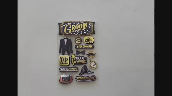 Female hands pick up and show in detail front and back of 3D scrapbook stickers featuring a tux, champagne and bow tie with gold and black details.