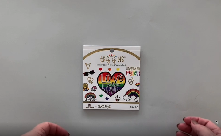 Female hands pick up and flip through the pages of this Love is Love "River &amp; Ink" planner stickers booklet to show each page of stickers in detail. There are twelve pages in this sticker book by Paper House Productions.